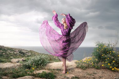 dancing woman in purple clothes