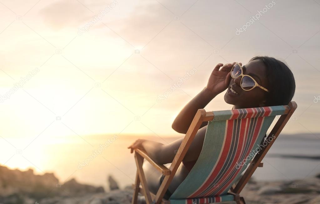 Black woman chilling by the sea