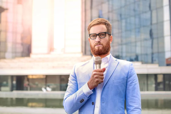 Businessman holding microphone — Stock Photo, Image