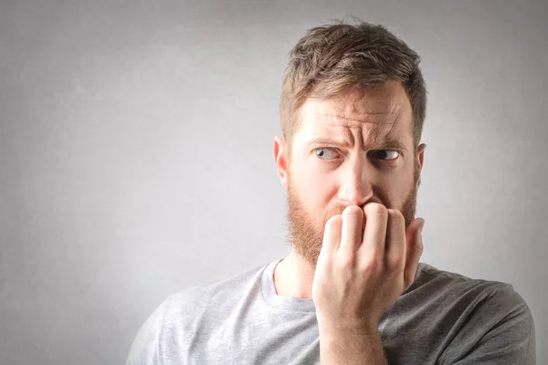 Man biting his nails — Stock Photo, Image