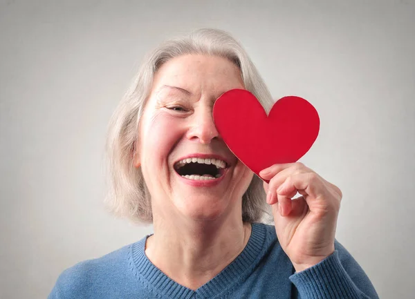 Signora anziana che tiene il cuore — Foto Stock