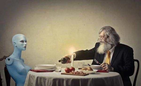 Old man having a dinner with a doll — Stock Photo, Image