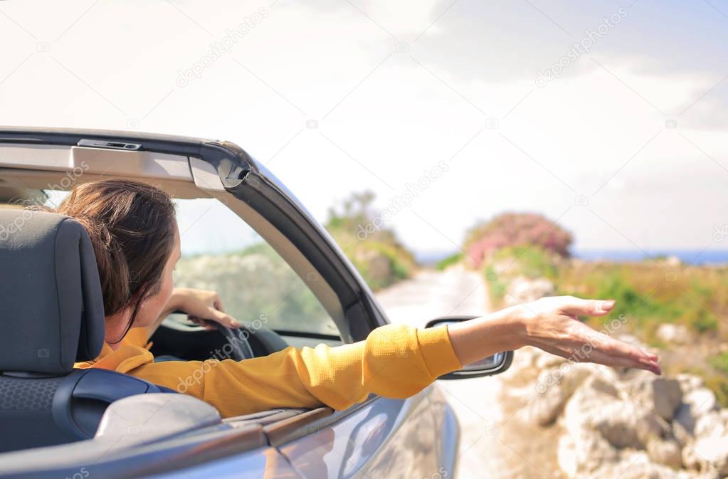 Woman driving car in the nature