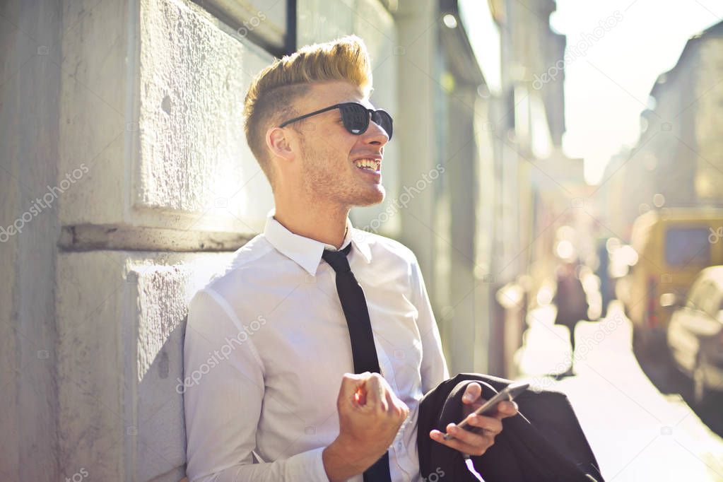 Blond businessman feeling happy outside