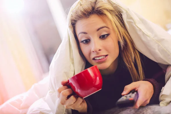 Blond woman watching TV — Stock Photo, Image