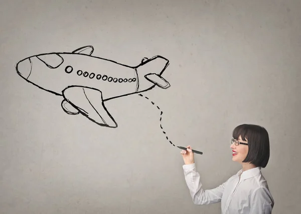 Woman drawing airplane — Stock Photo, Image