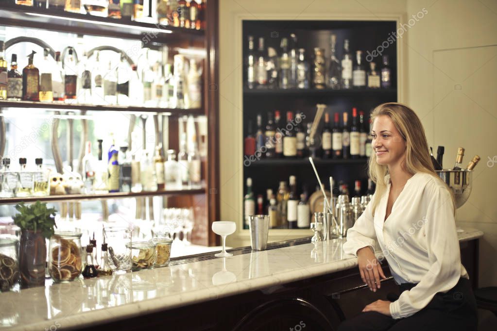 Smiling girl sitting in a bar 