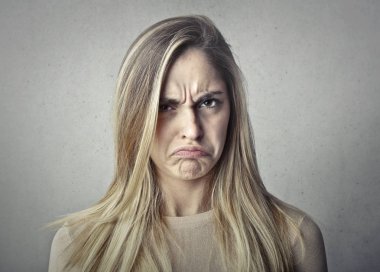 Blond girl with an angry expression clipart