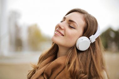 Gülümseyen kız kulaklık ile müzik dinlemek 
