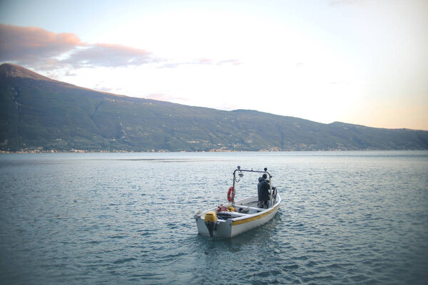 Boat with a fisherman sailing on the water