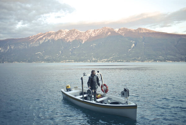 Man on a boat on a lake 