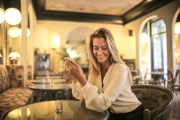Smiling girl sitting at a luxury bar