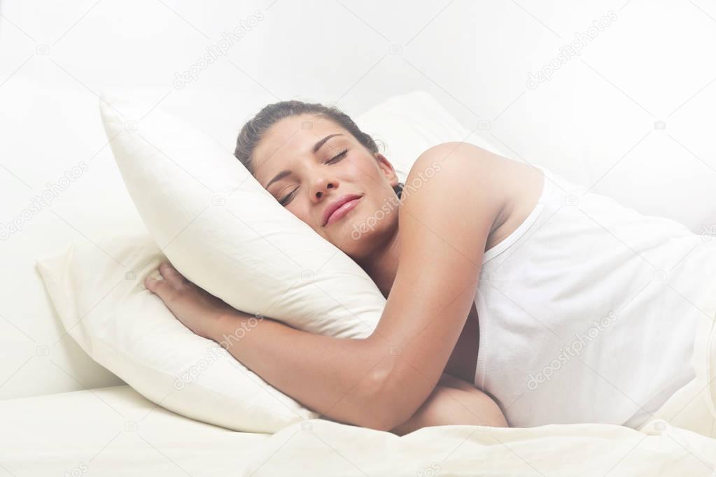 Girl sleeping in bed with two pillows 