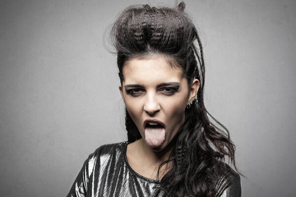 Young woman with an elaborate hairstyle making a disgusted expression