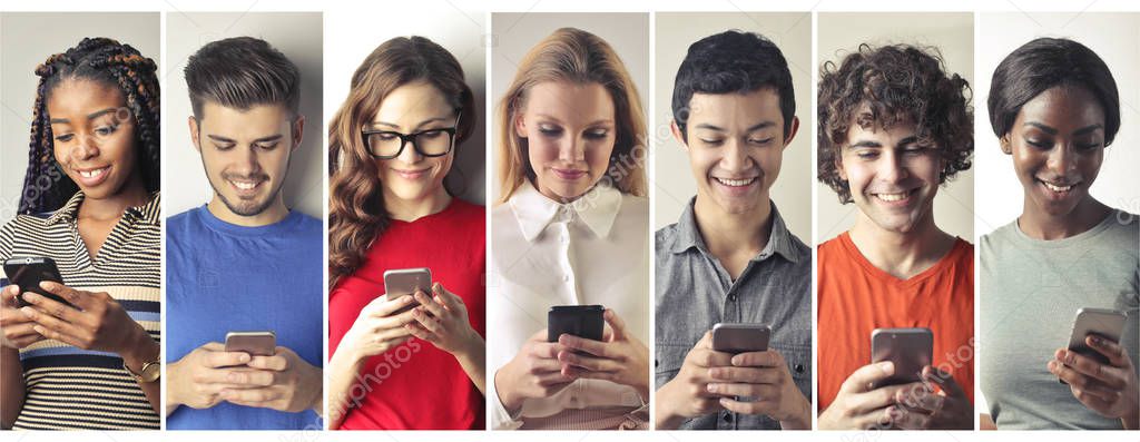 Seven young men and women using smartphones