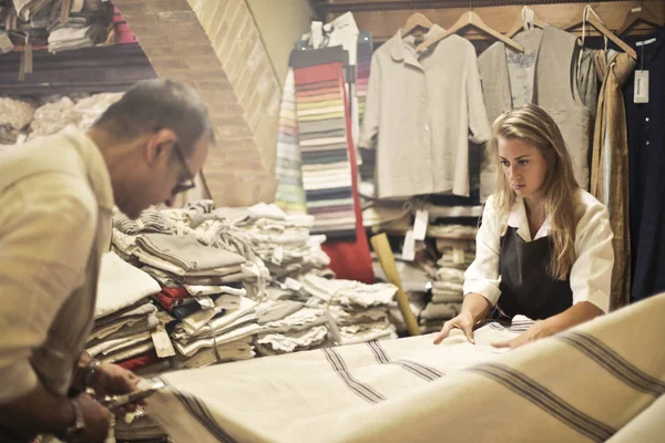 Two artisans at work with some fabrics in a laboratory