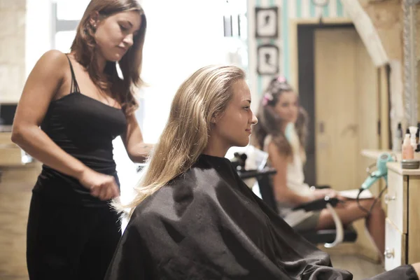 Hairdresser at work with client