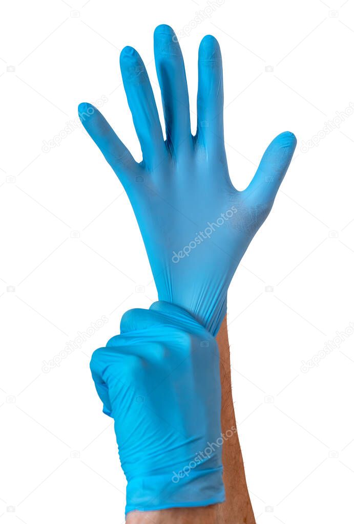 A Nurse Or Doctor Pulling On A Pair Of Surgical Gloves During The Coronavirus (COVID-19) Outbreak
