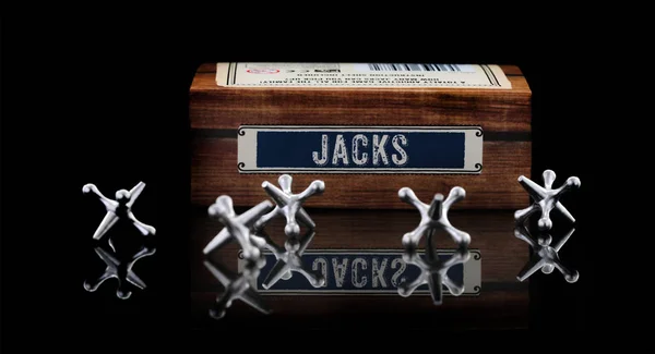 Game of Jacks on a black background — Stock Photo, Image