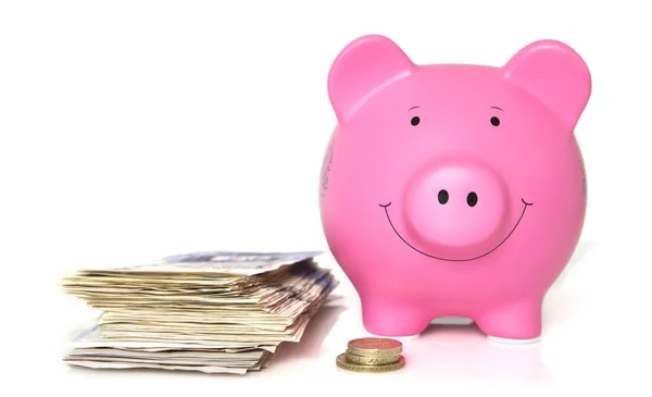 Pink Piggy Bank with a pile of banknotes and coins — Stock Photo, Image