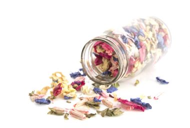 Colourful Potpourri in a jar on a white background clipart