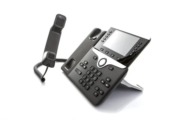 Téléphone IP de bureau moderne avec stylo sur fond blanc — Photo