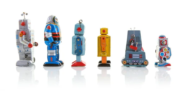 Row of old clockwork tin robots in a line on a white background — Stock Photo, Image