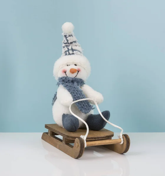 Snowman on a sledge — Stock Photo, Image