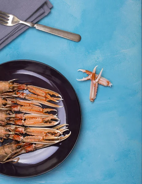 Cooked Langoustine Dark Plate Fork Napkin Blue Background — Stock Photo, Image