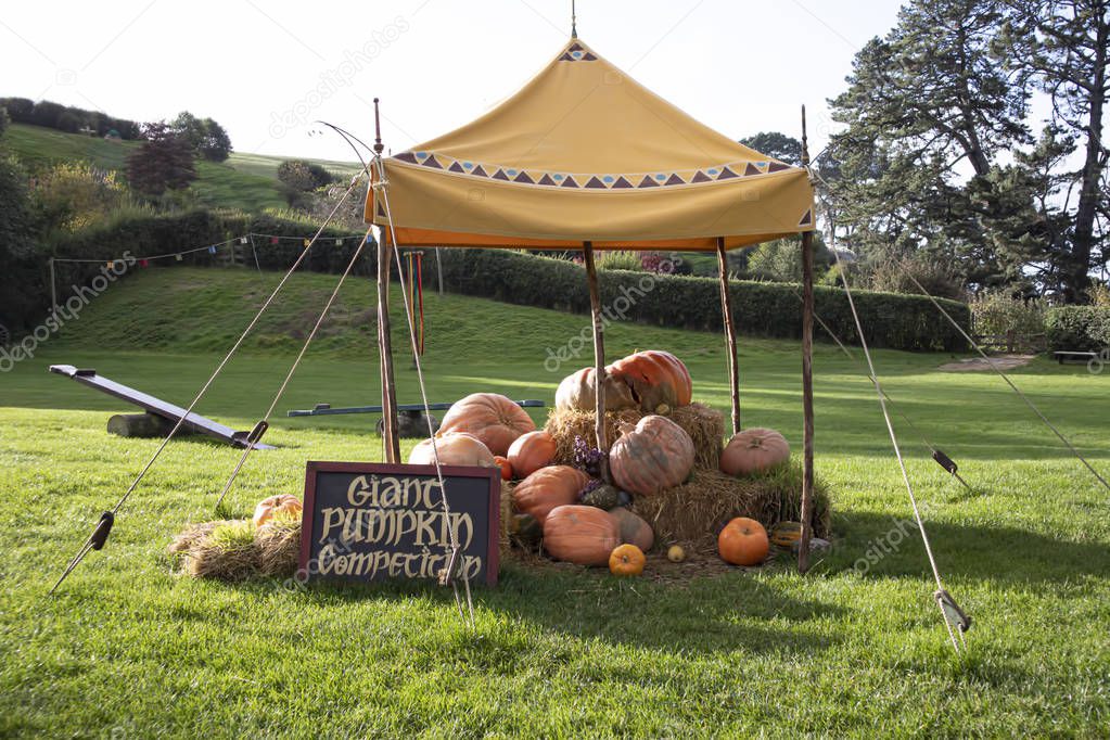 Giant pumpkin competition sign under a tent