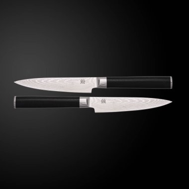 Two Japanese X100 Damascus kitchen knives on a dark background clipart
