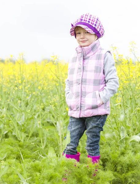 Маленька дівчинка в гумових чоботях у весняній природі — стокове фото