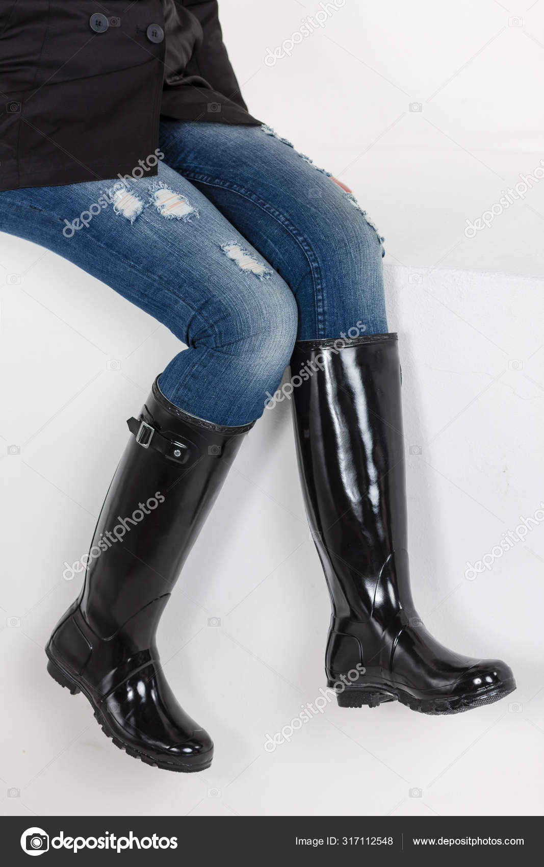 Women's black rubber boots with blue jeans Stock Photo by ©phb.cz 317112548