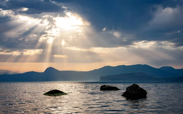 Por do sol sobre pedras no mar — Fotografia de Stock