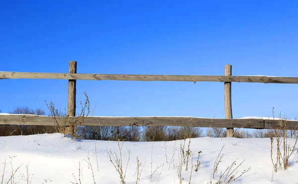 Cerca de madeira no dia de inverno no prado — Fotografia de Stock