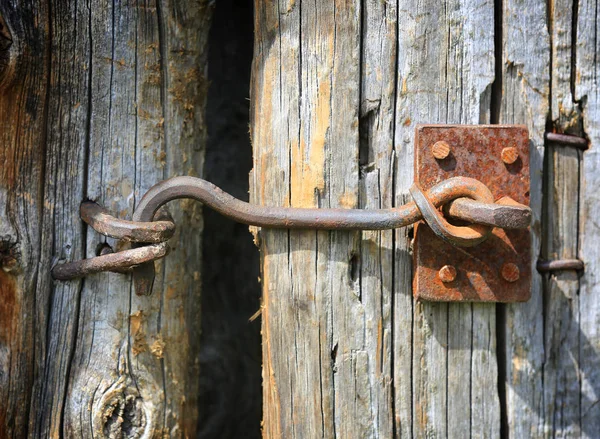 Metalen haak op houten deur — Stockfoto