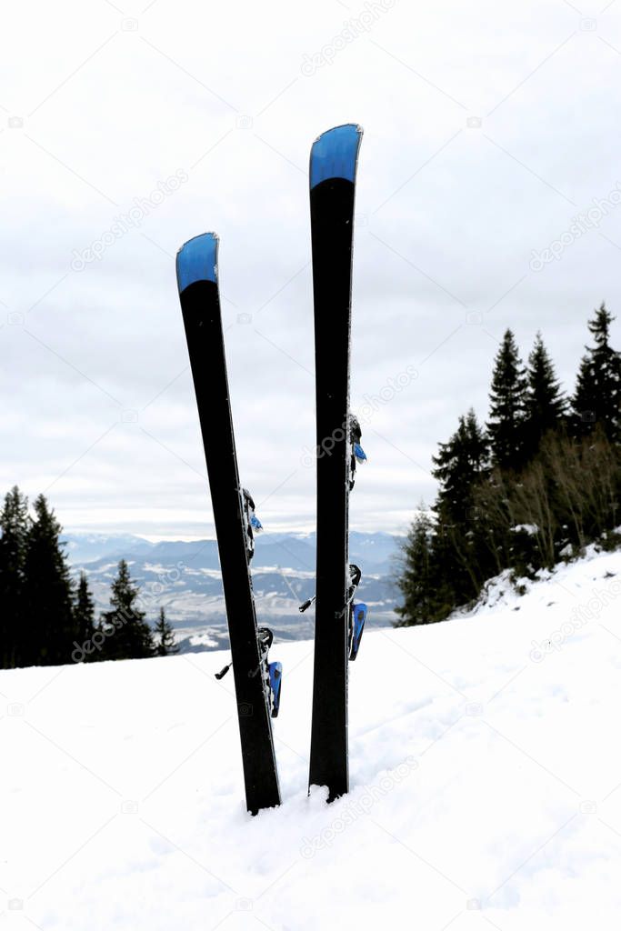 pair of mountain ski in snow