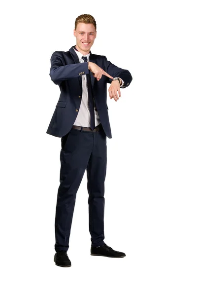 Young businessman dressed in a suit points to at watch — Stock Photo, Image