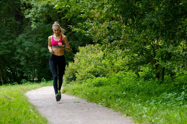 Jonge vrouw joggen in het park — Stockfoto