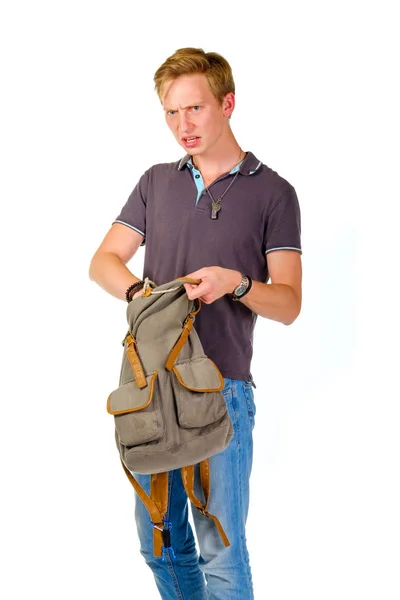 年轻人寻找内在他的背包里的东西 — 图库照片