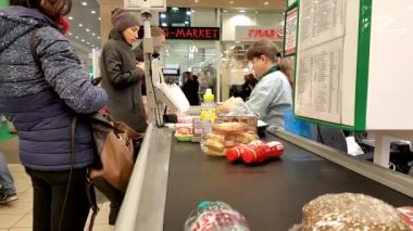 Kasiyer bir süpermarkette organizasyon müşterilerine hizmet vermektedir