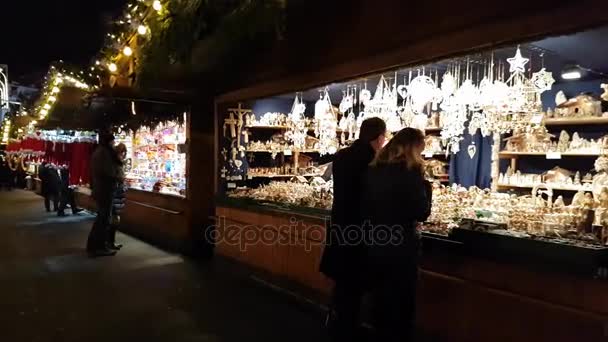 Ember látogat el a karácsonyi vásár közelében városháza este — Stock videók
