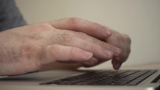 Male hands typing on a laptop keyboard — Stock Video