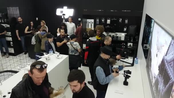 Customers testing Osmo stabilizers at the opening of DJI Store — Stock Video