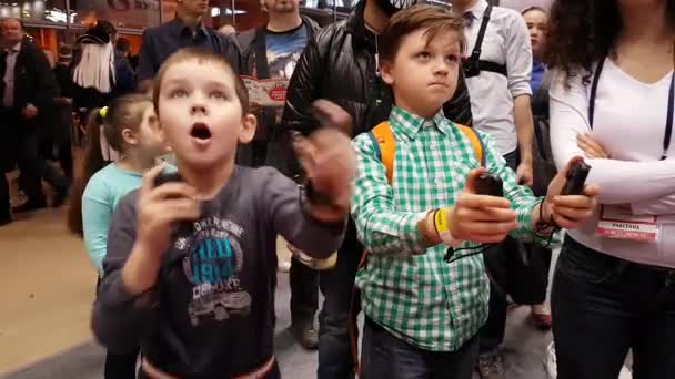 Visitors testing Nintendo gaming console — Stock Video