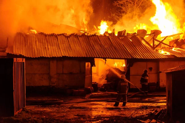 Bombeiros extinguem um incêndio — Fotografia de Stock