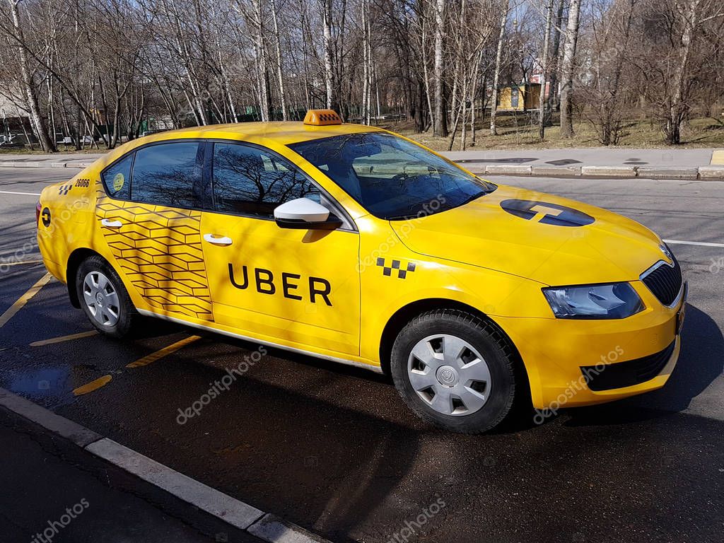 Moscow, Russia - April 11, 2017: New yellow taxi with Uber logo and inscription at the street