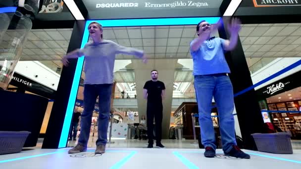 Los hombres juegan Galaxy fitness juego virtual en la tienda de la marca Samsung — Vídeos de Stock