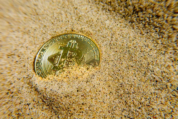 Golden bitcoin coin is in the sand — Stock Photo, Image