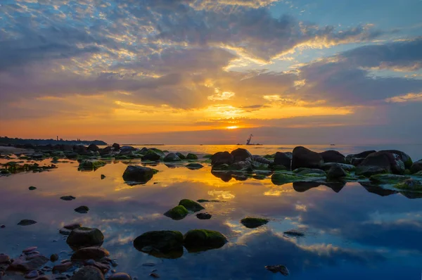 Pôr do sol sobre o mar, pedras em primeiro plano — Fotografia de Stock